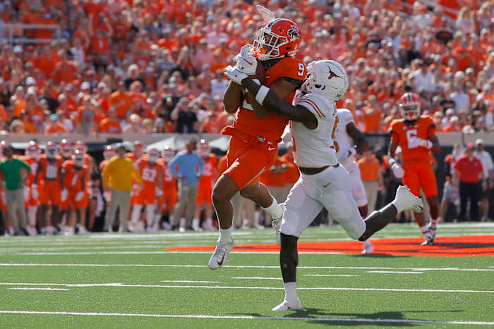 Oklahoma State Cowboys wide receiver Bryson Green (9) catches a pass in front of Texas Longhorns defensive back D'Shawn Jamison (5) during a college football game between the Oklahoma State Cowboys (OSU) and the University of Texas Longhorns at Boone Pickens Stadium in Stillwater, Okla., Saturday, Oct. 22, 2022. Oklahoma State won 41-34.